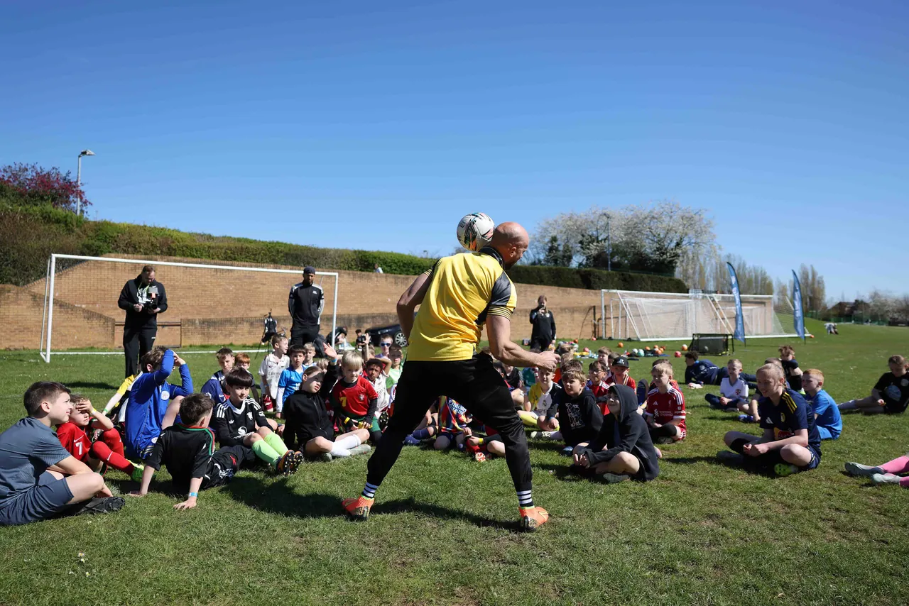 Kids cheering at a Daniel Cutting football camp