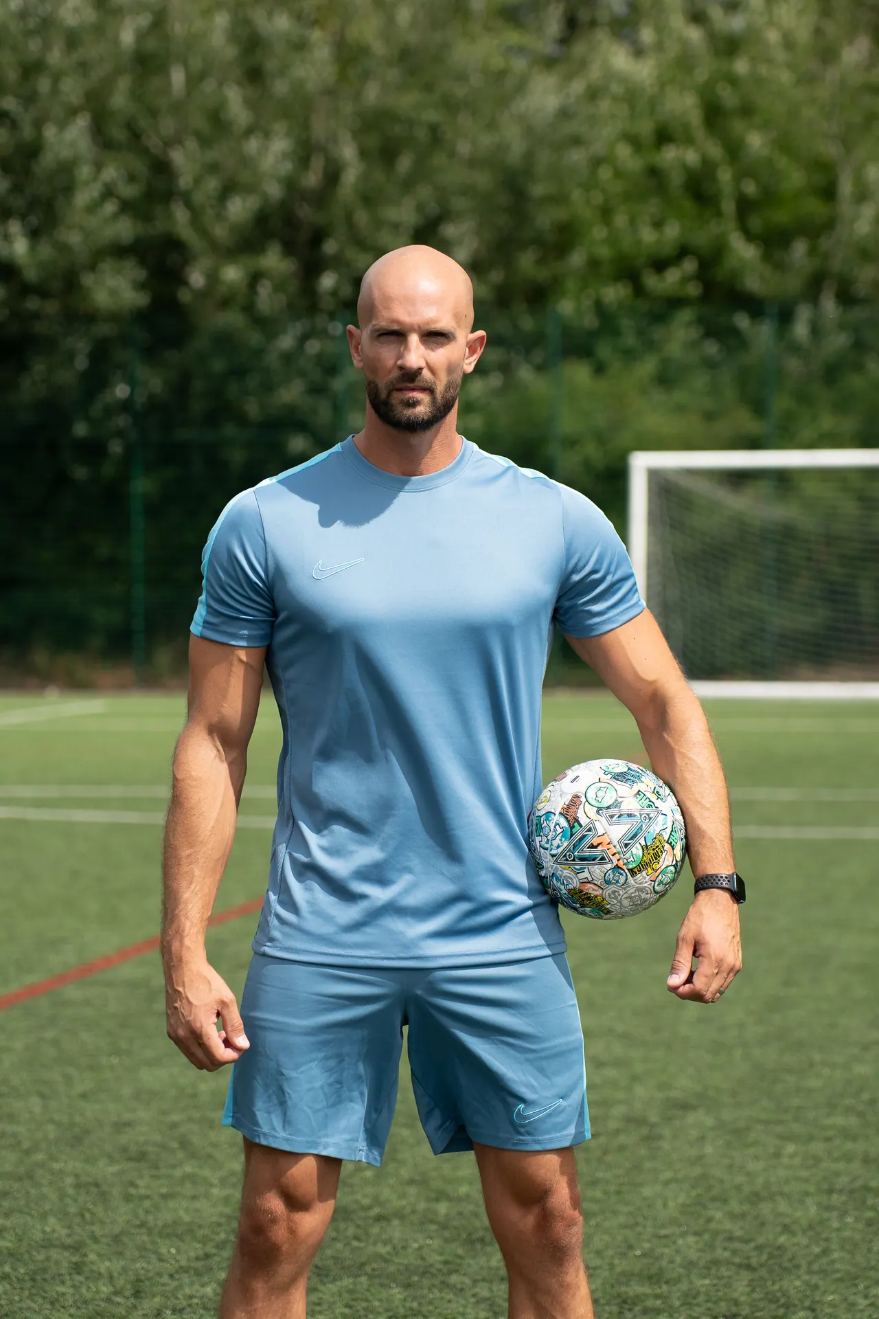 Daniel Cutting with a football on a pitch