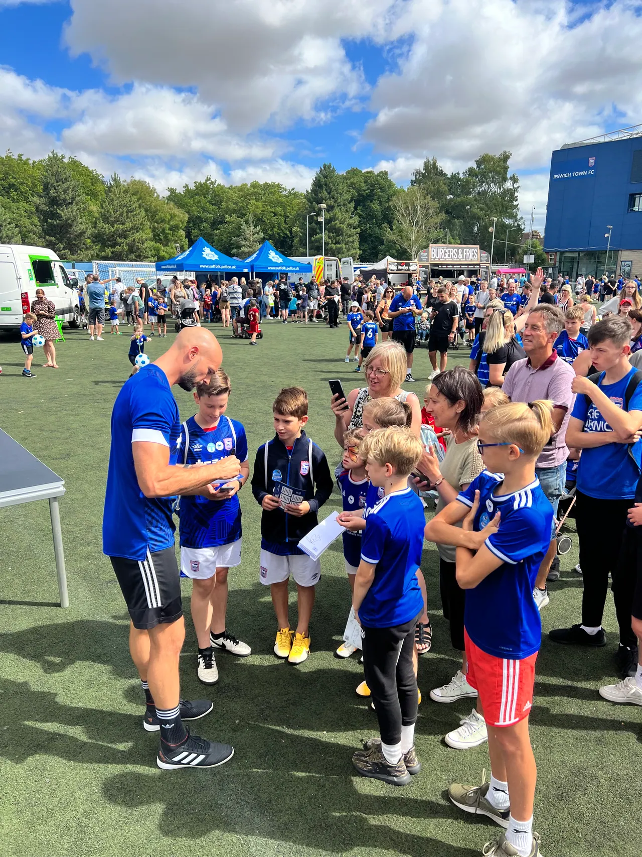 Daniel with a group of kids at a football camp
