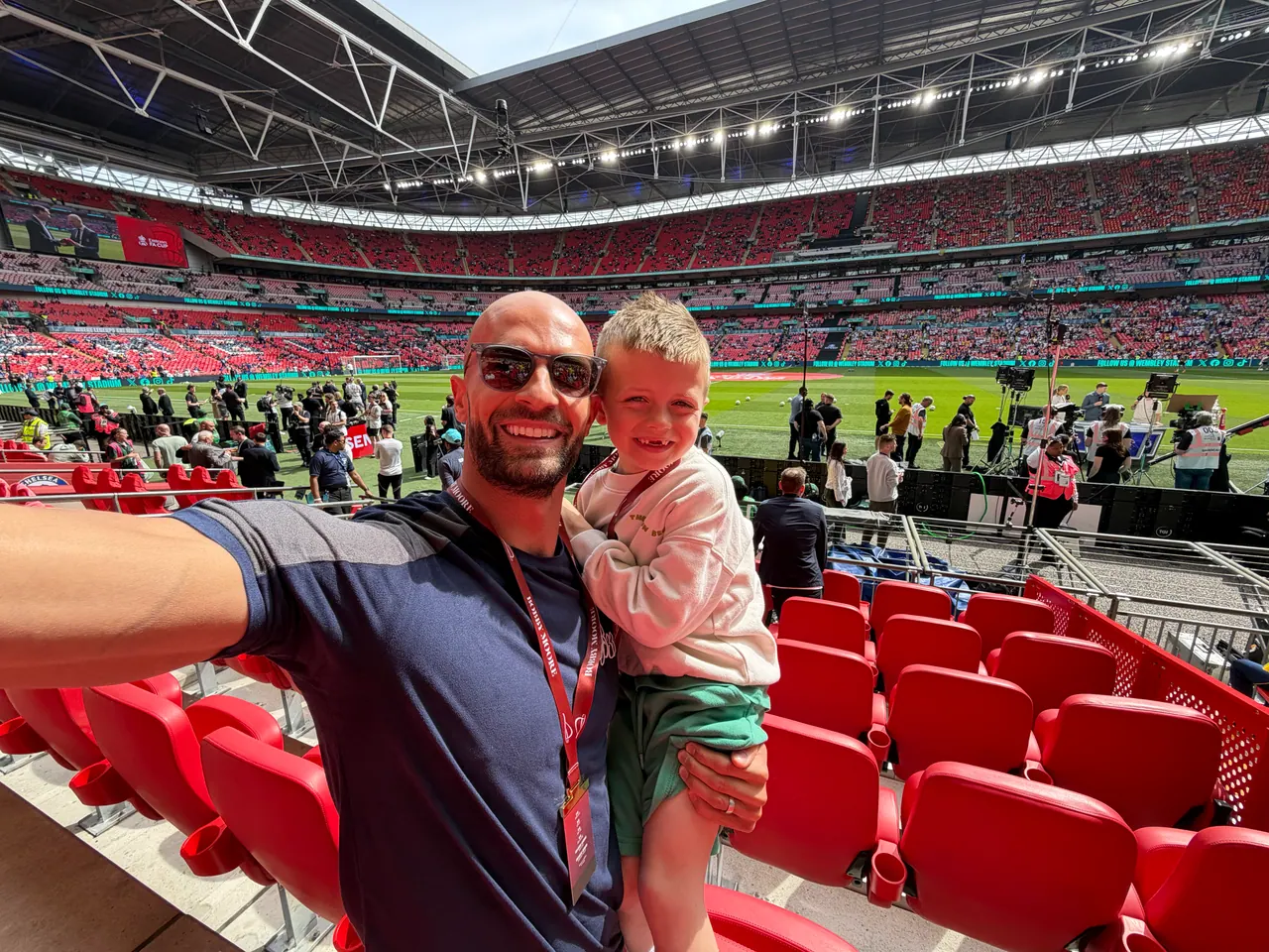 Daniel holding Joshua in the stands at Wembley