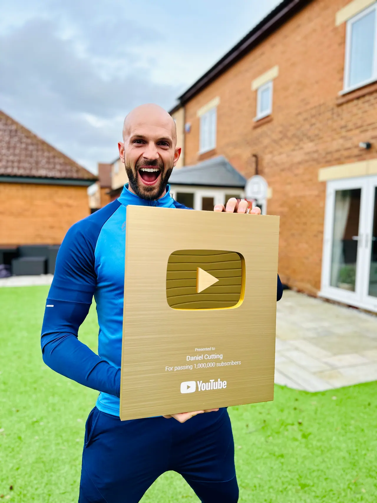 Daniel holding his YouTube Gold Play Button
