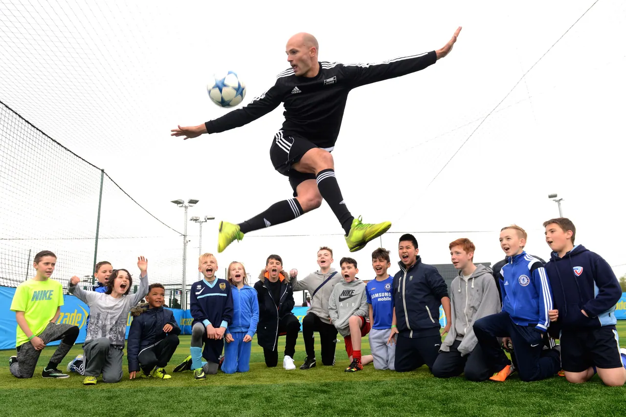 Daniel mid-trick in front of a group at a club event